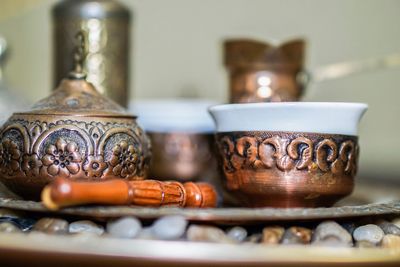 Close-up of ornate coffee cups on tray