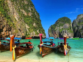 Boats moored on beach