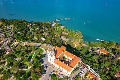 High angle view of townscape by sea against sky