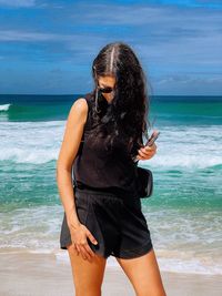 Young woman standing at beach