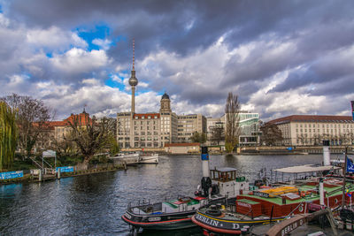 Boats in river with buildings in background