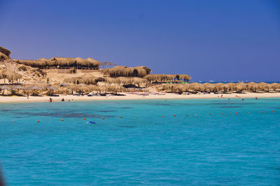 Scenic view of sea against clear blue sky