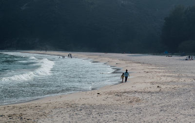 People on beach by sea