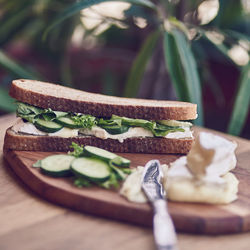 Close up of brie and cucumber sandwich