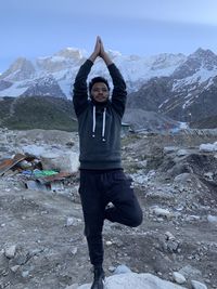 Full length of man standing on snow covered mountain
