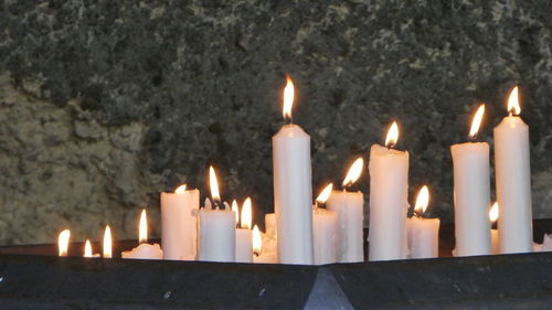 Close-up of burning candles in temple