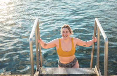 Portrait of smiling woman in sea