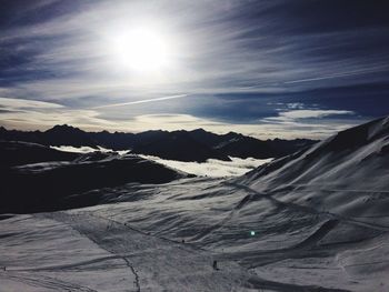 Scenic view of snow covered mountains against sky