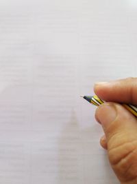 Close-up of person hand holding pen