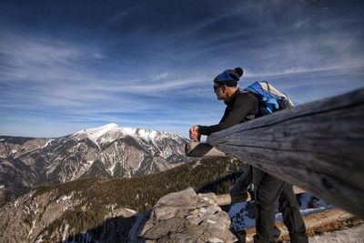 Man looking at mountain against sky