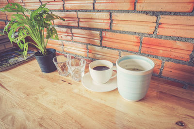 High angle view of hot chocolate and containers on table
