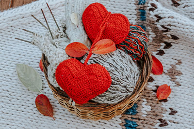 Autumn knitting of warm clothes. woolen balls of knitting needles knitted hearts. self-made 