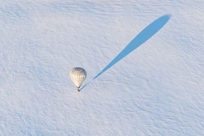 High angle view of hot air balloon on snow covered field