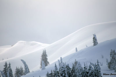 Scenic view of snow covered mountains against sky