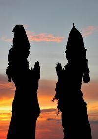 Silhouette people against sky during sunset