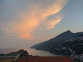 Scenic view of coast against sky during sunset