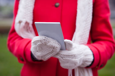 Close-up of hand holding smart phone during winter