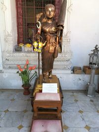 Statue of buddha against wall in building