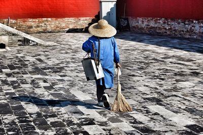 Rear view of woman walking on footpath