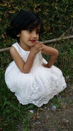 High angle portrait of girl lying on land