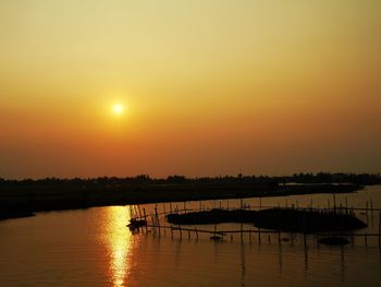 Scenic view of river against clear sky during sunset