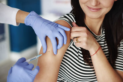 Woman receiving an injection in her arm