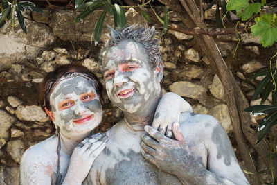 Portrait of smiling man and woman with facial mask on face