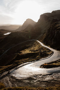 Road by mountain against sky