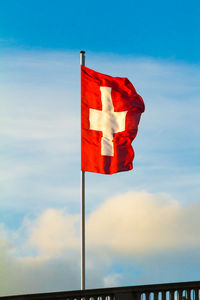 Low angle view of flag on pole against sky