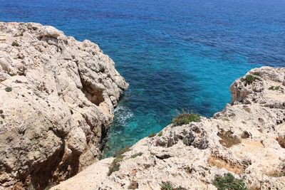 High angle view of rocks by sea