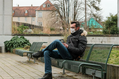 Portrait of young man sitting on bench