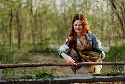 Young woman with bowl at farm