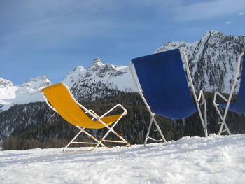 Umbrella on snow covered field against sky