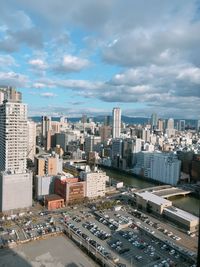 Aerial view of modern buildings in city against sky