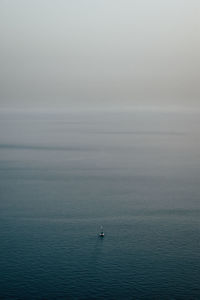 Scenic view of sea against sky and a boat