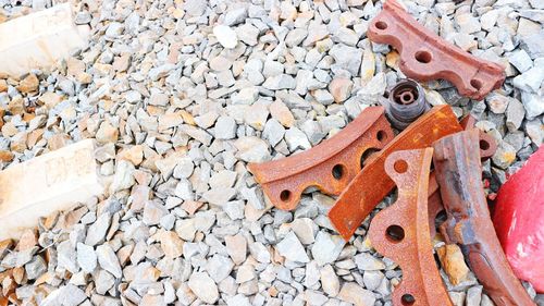 High angle view of rusty metal on rock