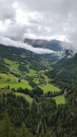 Scenic view of mountains against cloudy sky