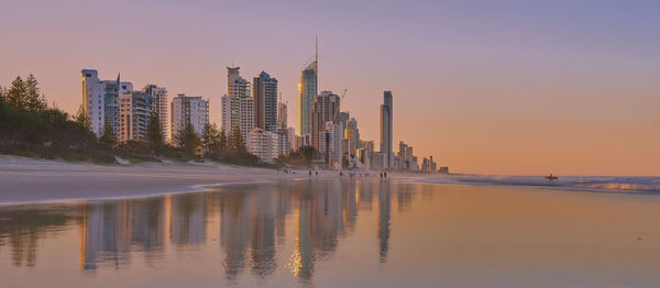 View of city at waterfront during sunset