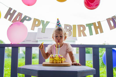 Portrait of boy playing with balloons