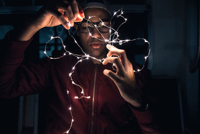 Man holding christmas lights