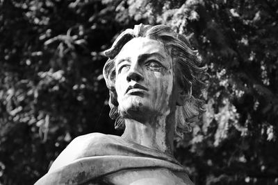 Low angle view of statue against trees