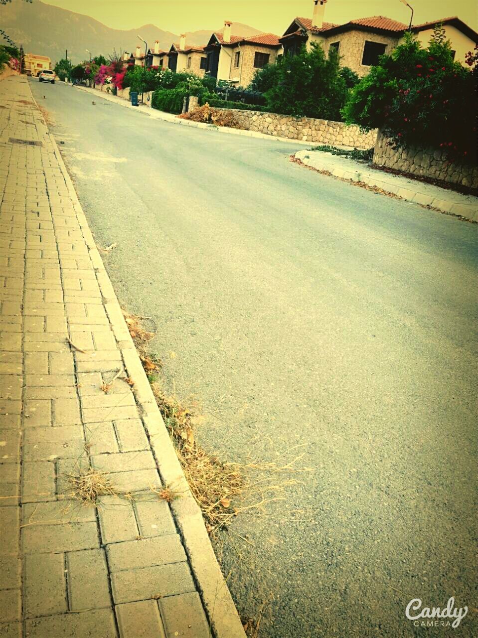 street, road, building exterior, road marking, transportation, city, the way forward, architecture, built structure, high angle view, asphalt, incidental people, car, outdoors, city street, city life, day, diminishing perspective, land vehicle, vanishing point