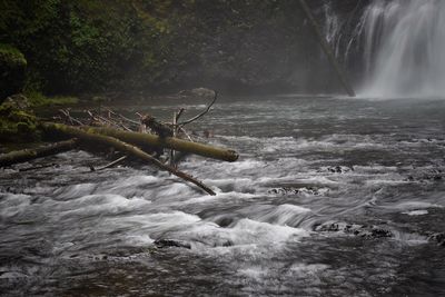 Scenic view of waterfall against sky