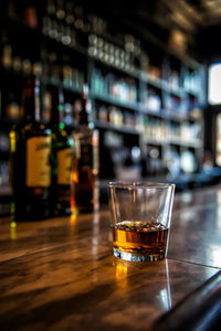 Close-up of whiskey in glass on table