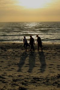 People on beach at sunset
