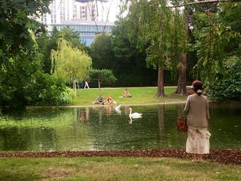 Rear view of people standing in park