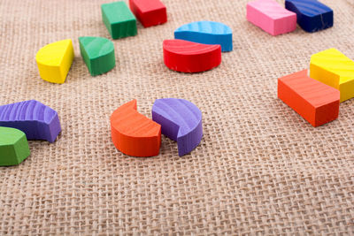 Close-up of colorful wooden toys on burlap