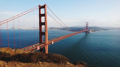 Golden gate bridge over river against sky