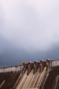 Low angle view of dam against sky
