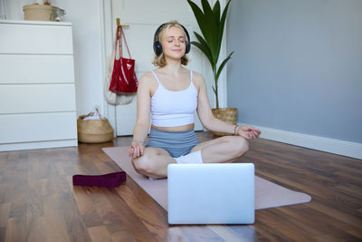 Portrait of young woman using laptop on table